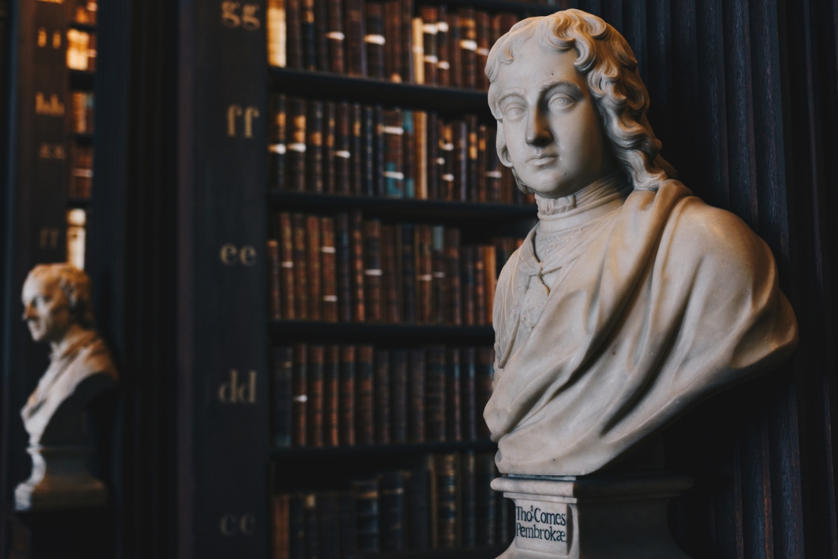 Busts by the bookshelves